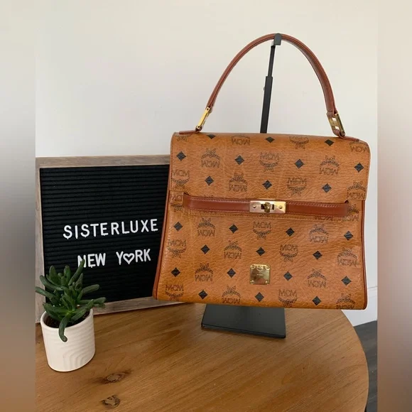Authentic MCM Heritage Top Handle Bag in Cognac Visetos